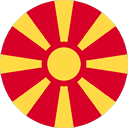 A circular flag with a red background and a yellow sun with eight extending rays.