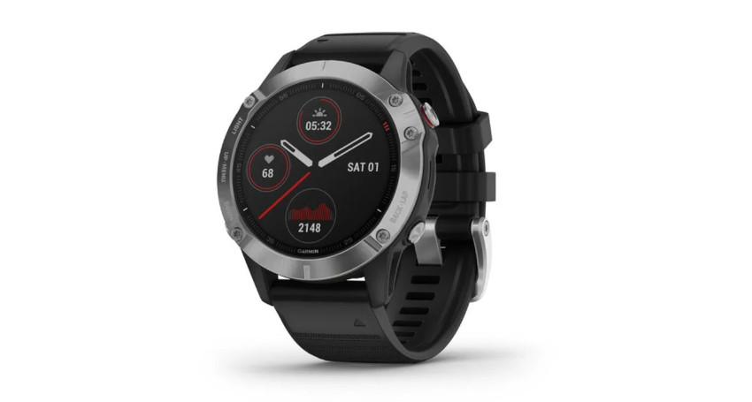 Black and silver smartwatch displaying heart rate, steps, and date with a round face and black strap against a white background.