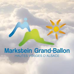 Logo of Markstein Grand-Ballon with stylized mountains and sun, against a cloudy sky background. Text below reads "Hautes Vosges d'Alsace.