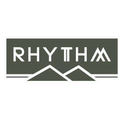 A logo featuring the word "RHYTHM" in white uppercase letters on a dark green background with stylized mountain peaks below the text.