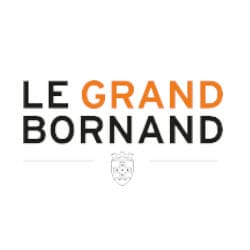Logo of Le Grand-Bornand with the text "LE GRAND BORNAND" in black and orange letters and a small emblem underneath.