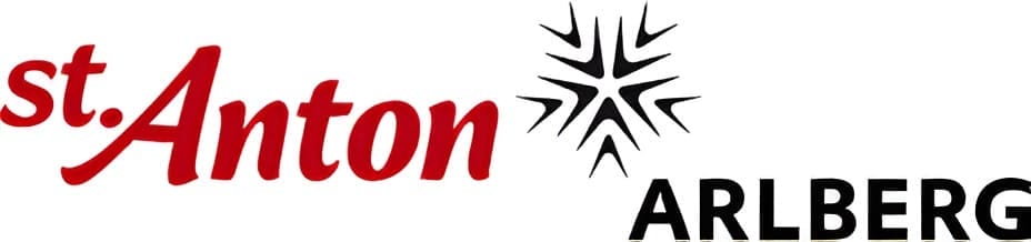 Logo of St. Anton Arlberg, with "st. Anton" in red cursive font, a black snowflake symbol, and "ARLBERG" in black capital letters.