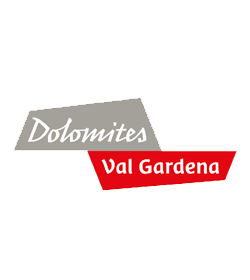 Logo of Dolomites Val Gardena featuring grey and red geometric shapes with the words "Dolomites" and "Val Gardena.