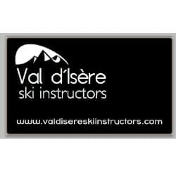 A black sign with white text that reads "Val d’Isère ski instructors" and has a mountain graphic. Below, a website URL is listed: www.valdisereskiinstructors.com.