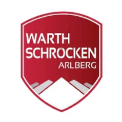 Red and white shield-shaped logo with the words "Warth Schröcken Arlberg" above a stylized depiction of a mountain.